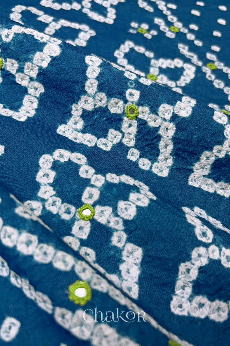 Hand tied Bandhani floral motif with colourful mirror embroidery on Indigo Blue cotton fabric.

