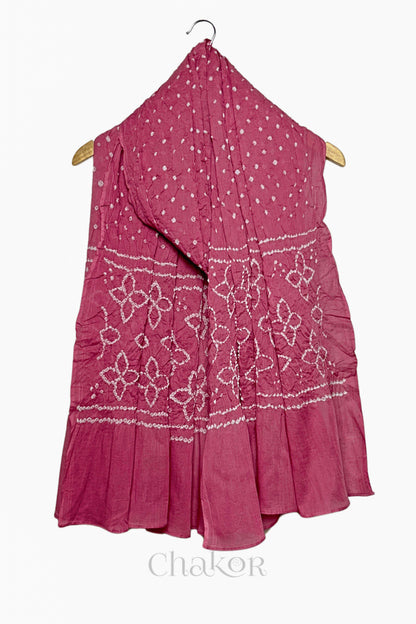 Rose Pink mercerised mulmul cotton dupatta with Bandhani floral pallu design draped on hanger.
