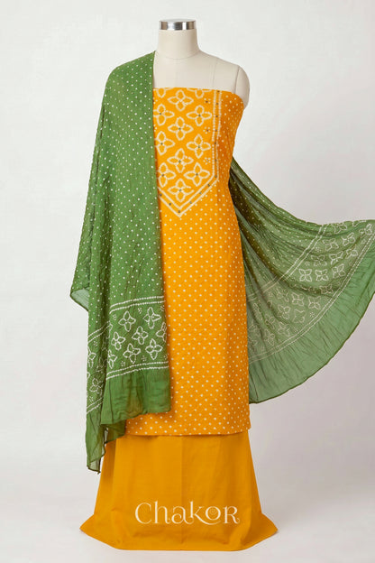 Yellow Kutch Bandhani cotton unstitched suit set, mirror work kurta with Green mulmul cotton dupatta.
