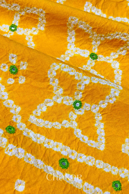 Close-up of Bandhani floral pattern accented with hand embroidery Yellow mirror work.
