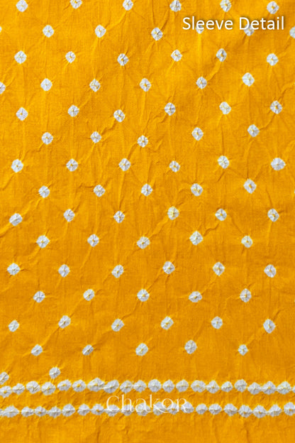 Bandhani dotted sleeve pattern on mercerised cotton fabric with handcrafted tie dye work.
