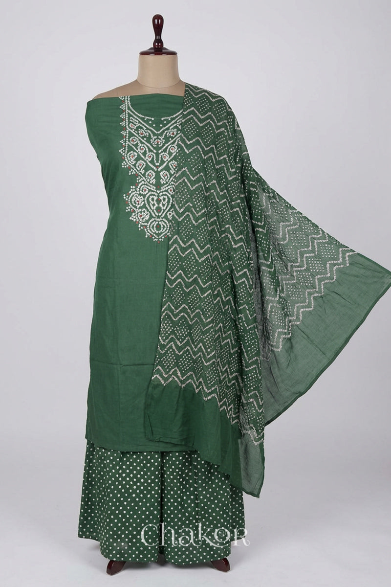A stylish moss green set fabric featuring mirror embroidered yoke, matching coloured bandhani bottom and dupatta draped on a dressform.