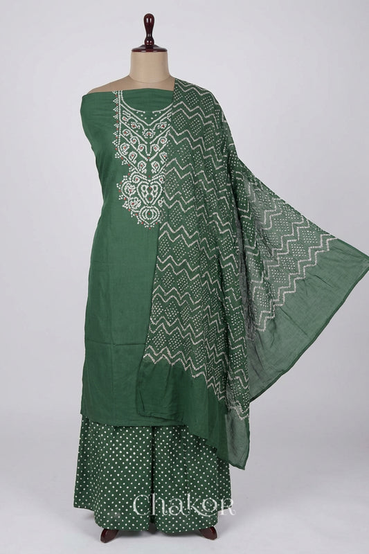 A stylish moss green set fabric featuring mirror embroidered yoke, matching coloured bandhani bottom and dupatta draped on a dressform.