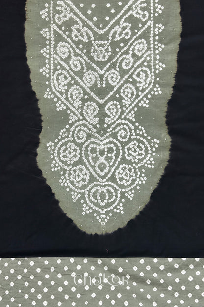 Close-up of black kurta fabric featuring intricate bandhani & cement grey mukaish embroidered yoke with bandhani dotted bottom fabric, with Chakor brand watermark.
