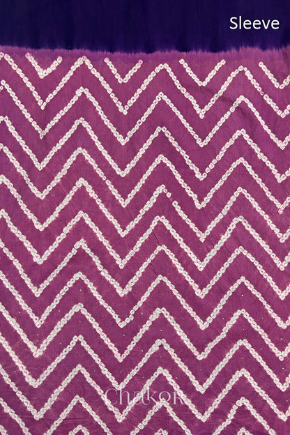 Close-up of violet puprle bandhani fabric featuring chevron tie-dye design, with Chakor brand watermark. Text reads sleeve.
