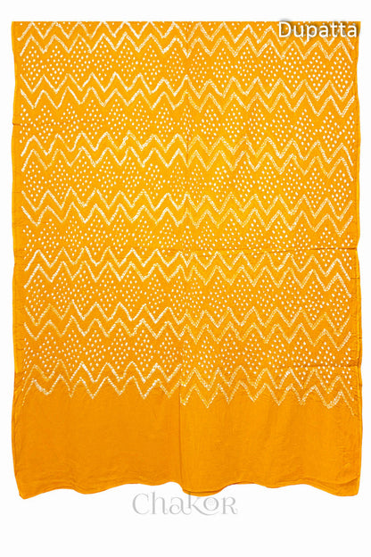 Full view of the yellow dupatta from the kurta set with intricate zigzag bandhani patterns, with Chakor watermark. The design showcases artisanal craftsmanship.
