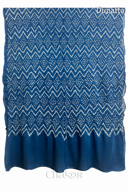 Full view of the indigo blue dupatta from the kurta set with intricate zigzag bandhani patterns, with Chakor watermark. The design showcases artisanal craftsmanship.
