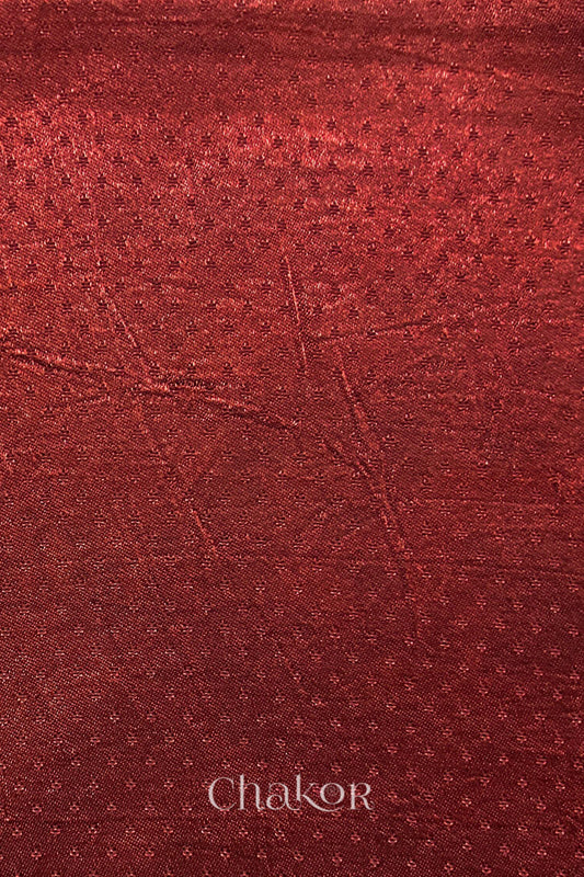 brick red mashru self textured fabric with 'Chakor' logo visible.
