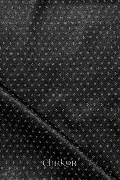 Black mashru self textured fabric with 'Chakor' logo visible.