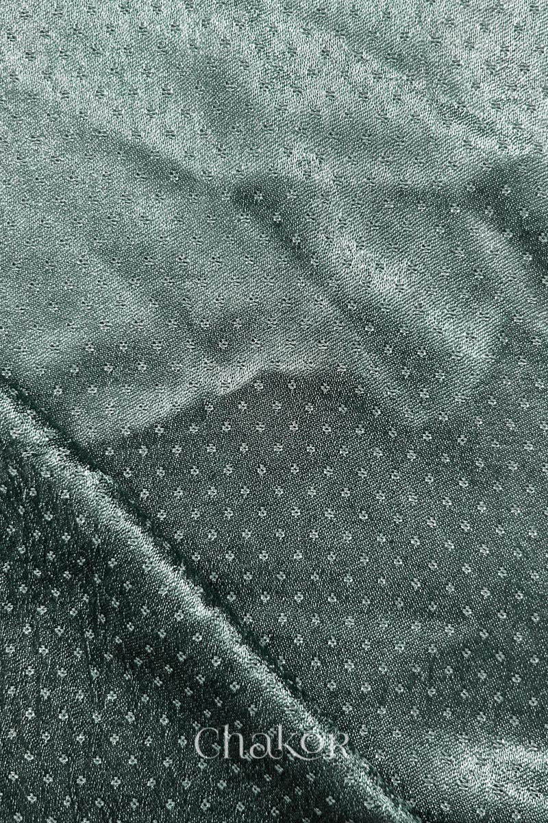Charcoal grey mashru self textured fabric with folded corner & Chakor brand watermark.