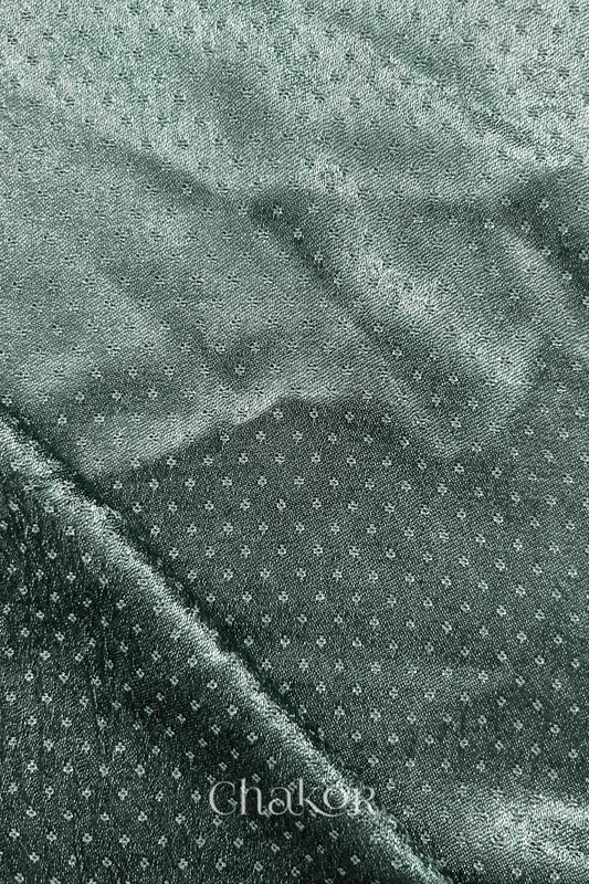 Charcoal grey mashru self textured fabric with folded corner & Chakor brand watermark.