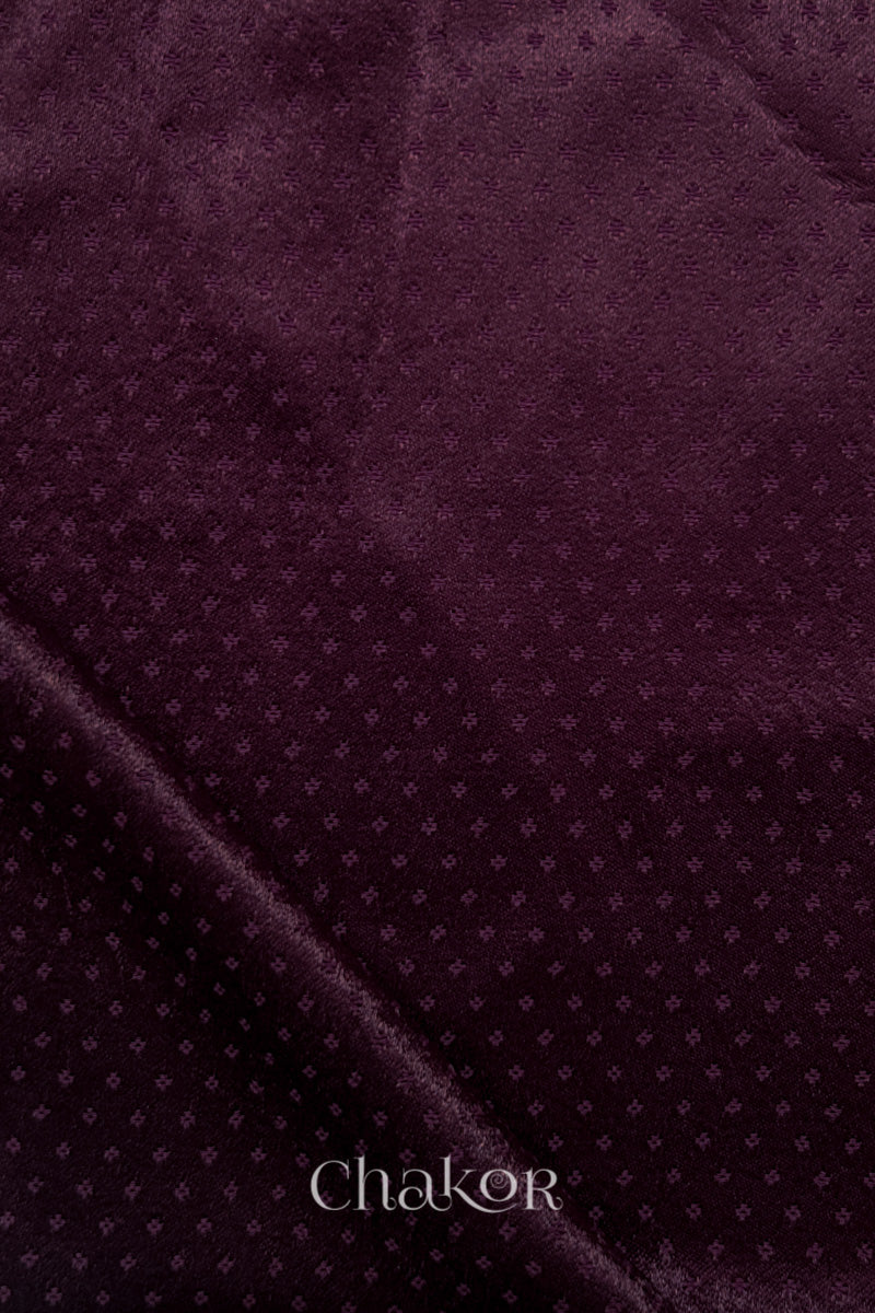 dark burgundy mashru self textured fabric with folded corner & Chakor brand watermark.