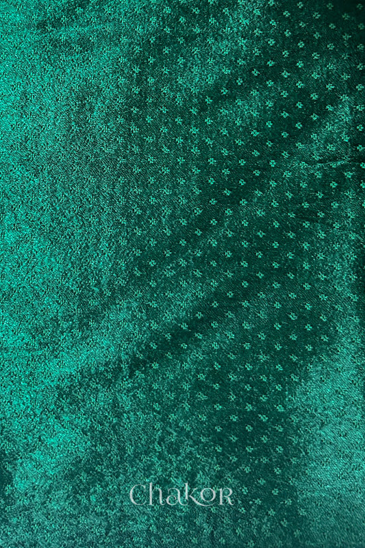 dark green mashru self textured fabric with 'Chakor' logo visible.
