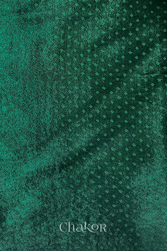 dark green mashru self textured fabric with 'Chakor' logo visible.
