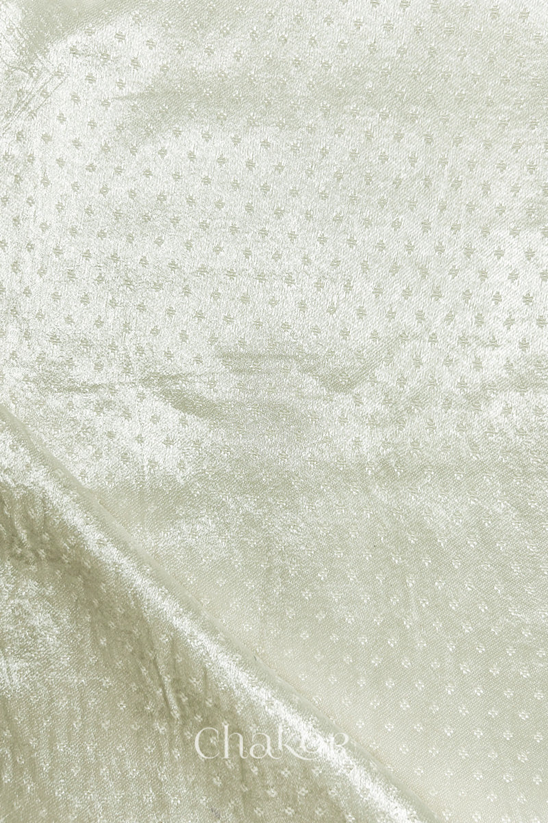 Off-white mashru self textured fabric with folded corner & Chakor brand watermark.