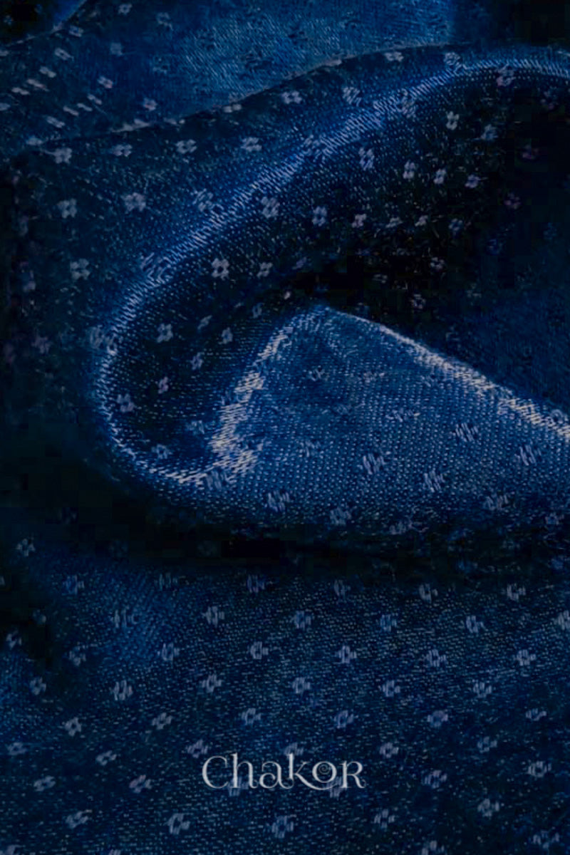 Close-up of navy mashru self textured fabric with 'Chakor' logo visible.