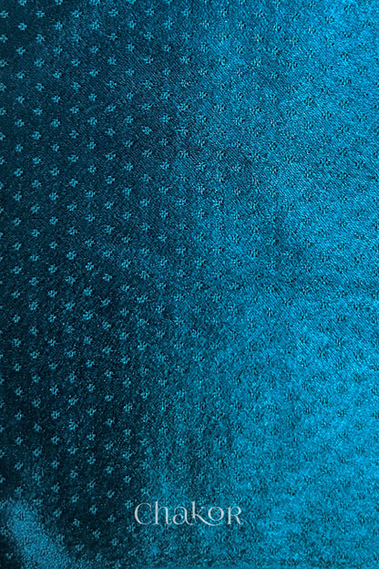 deep indigo mashru self textured fabric with 'Chakor' logo visible.
