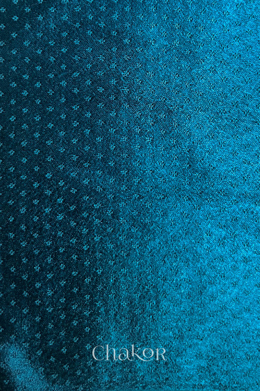 deep indigo mashru self textured fabric with 'Chakor' logo visible.

