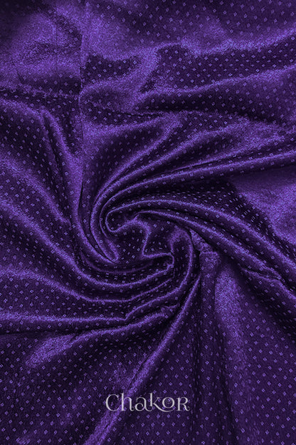Purple Mashru blouse fabric with silky texture, fabric swirl close-up.
