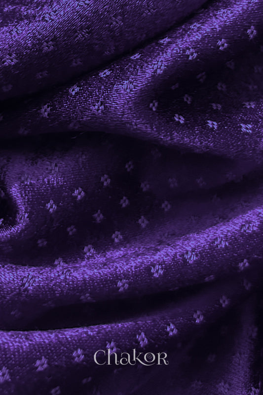 Close-up of purple mashru blouse fabric with a self-textured pattern, branded 'Chakor'.
