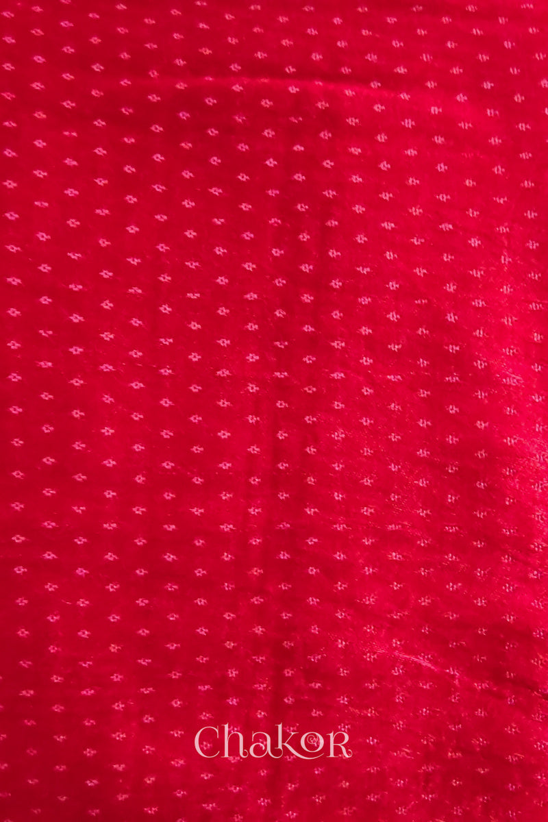 Red mashru self textured fabric with 'Chakor' logo visible.