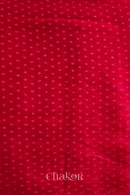 Red mashru self textured fabric with 'Chakor' logo visible.