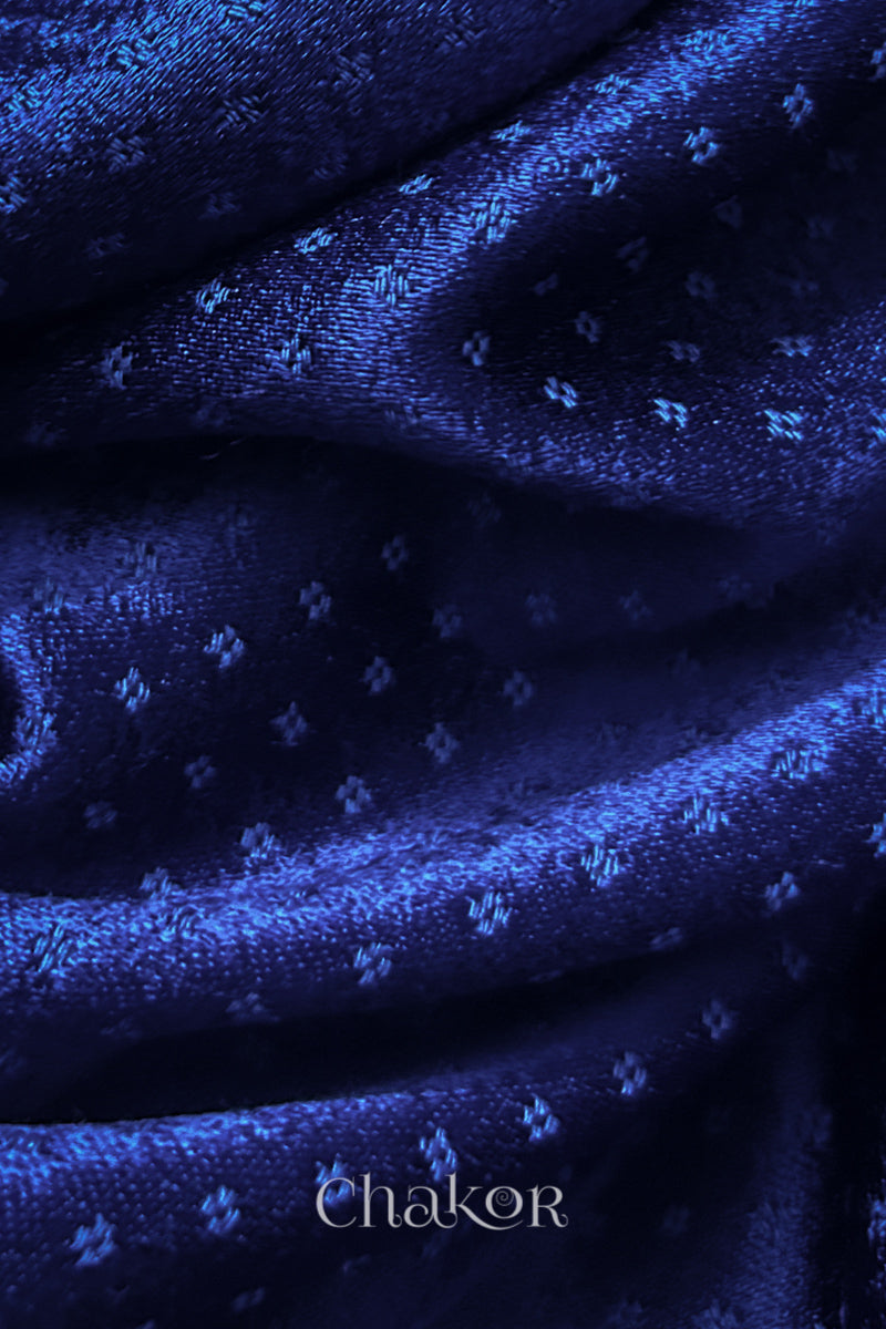 Close-up of royal blue mashru self textured fabric with 'Chakor' logo visible.