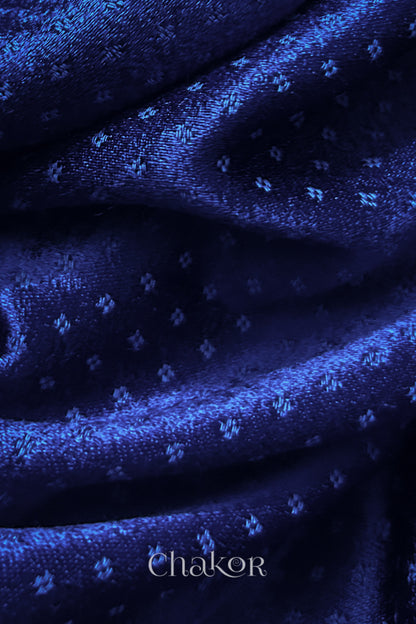 Close-up of royal blue mashru self textured fabric with 'Chakor' logo visible.