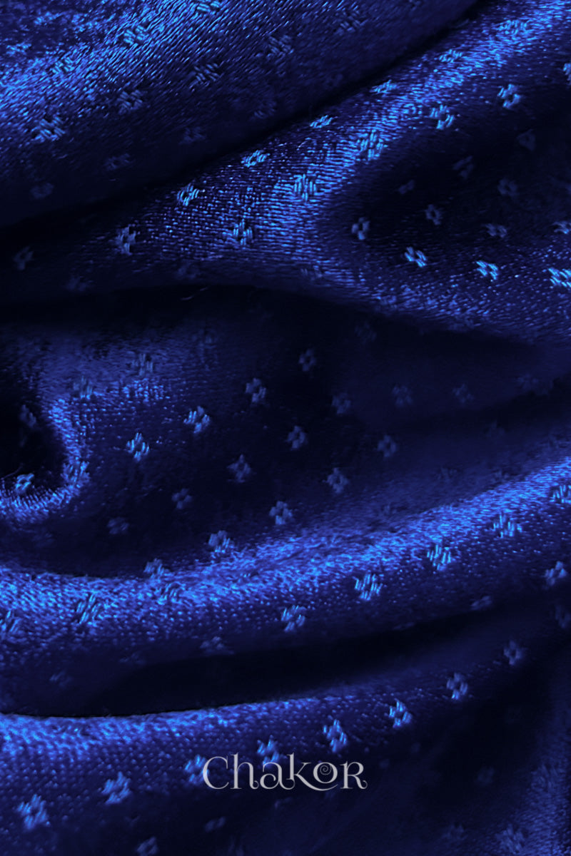 Close-up of royal blue mashru self textured fabric with 'Chakor' logo visible.