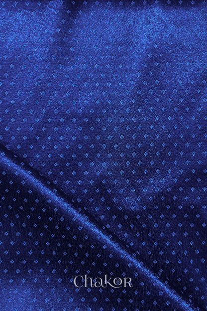 Royal blue mashru self textured fabric with folded corner & Chakor brand watermark.