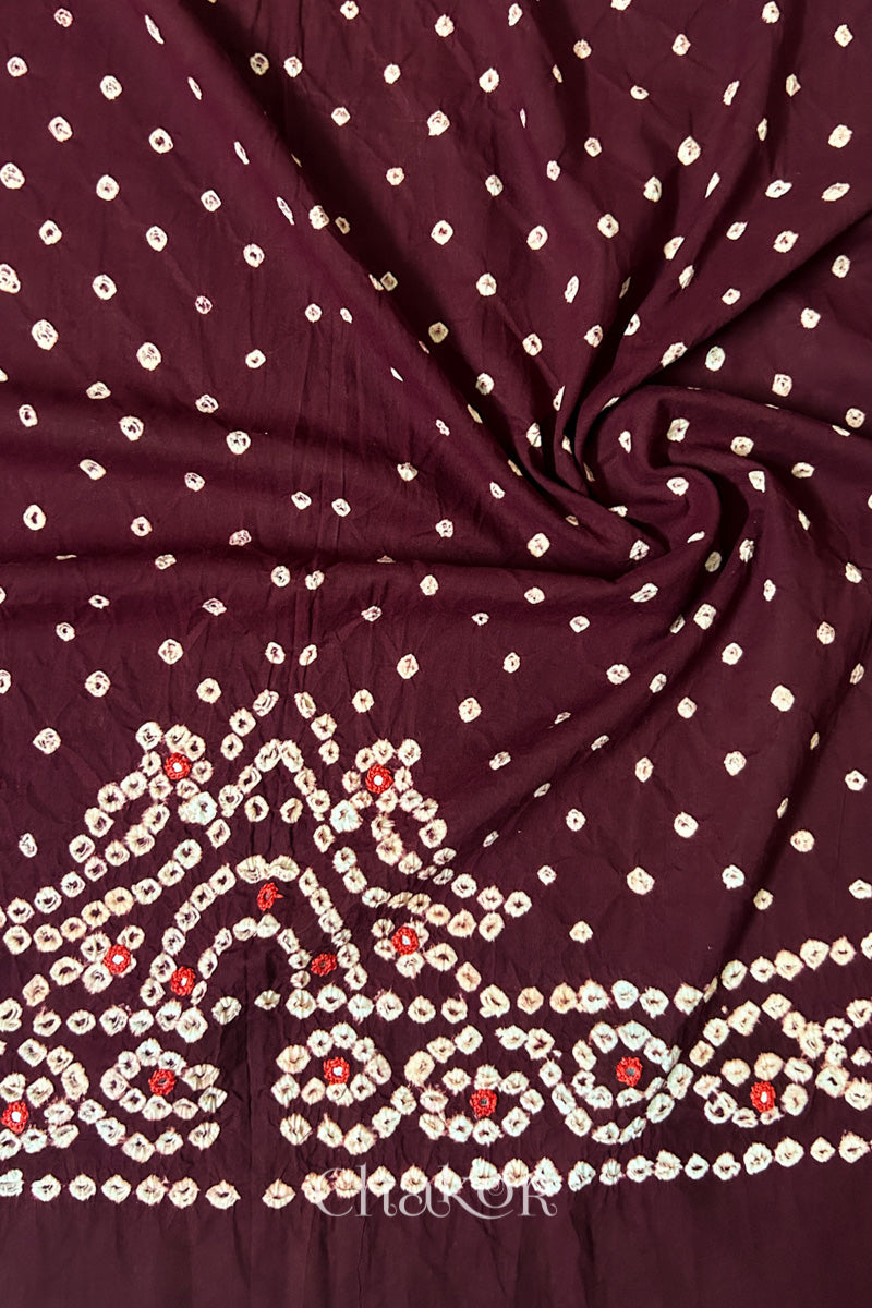 Maroon Bandhani cambric cotton blouse fabric showing its soft drape and hand-tied pattern.
