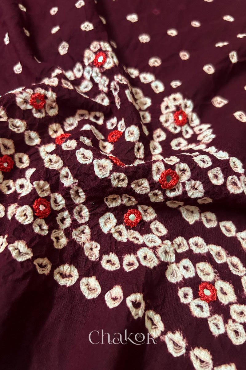 Detailed Popat Bandhani pattern with hand-embroidered mirrors on Maroon cambric cotton blouse piece.
