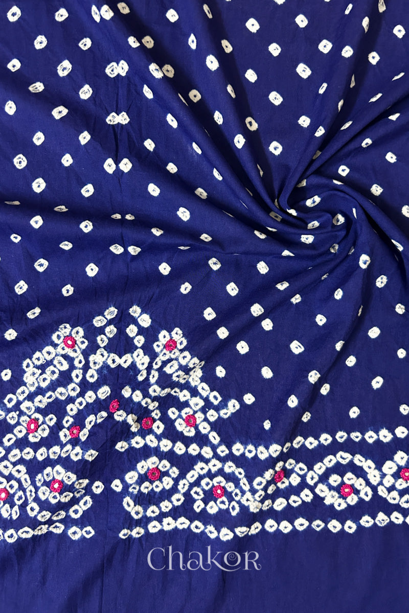 Navy blue Bandhani cambric cotton blouse fabric showing its soft drape and hand-tied pattern.
