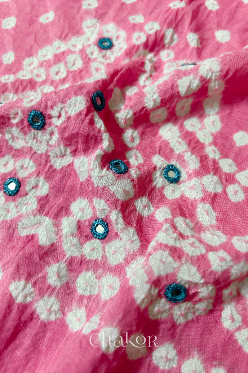 Close-up of Popat Bandhani motifs and hand-embroidered mirror work on Pink blouse fabric.

