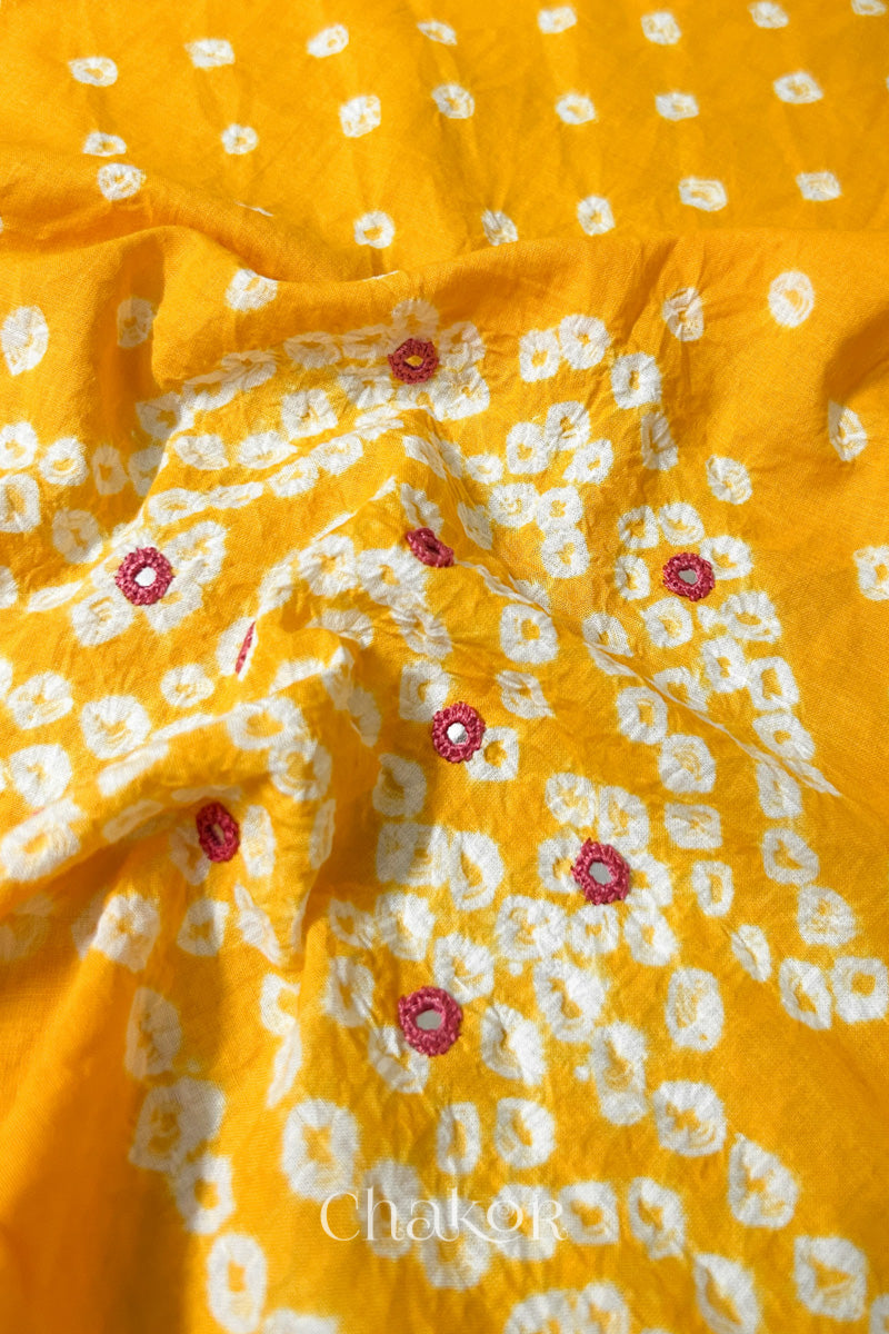 Detailed Popat Bandhani pattern with hand-embroidered mirrors on Yellow cambric cotton blouse piece.
