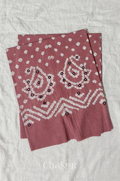 Turquoise Kutch Bandhani cotton unstitched blouse fabric with Keri pattern piece folded on white fabric.
