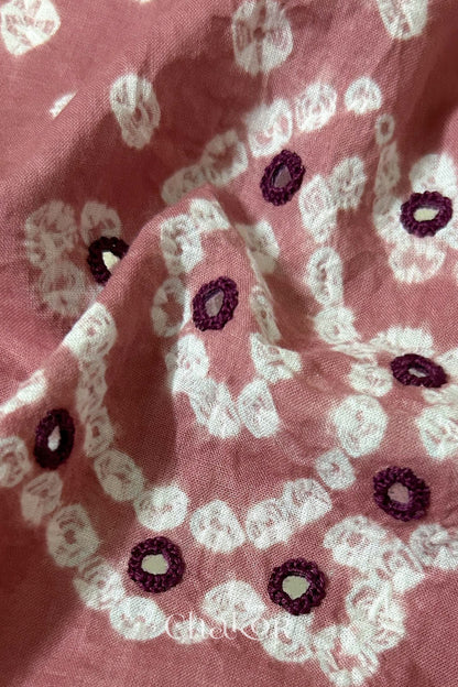 Close-up of Turquoise Kutch Bandhani blouse fabric showing Keri motifs and hand-embroidered mirror work.
