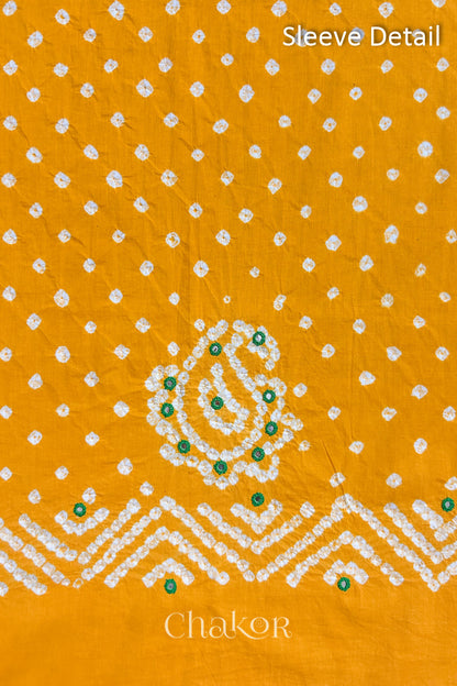 Yellow Kutch Bandhani cotton fabric with white tie-dye dots and Keri motif detail for sleeves.
