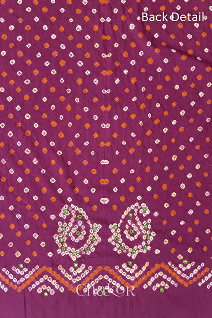 Close-up of Magenta Kutch Bandhani fabric with white dotted pattern and Keri motifs for back.
