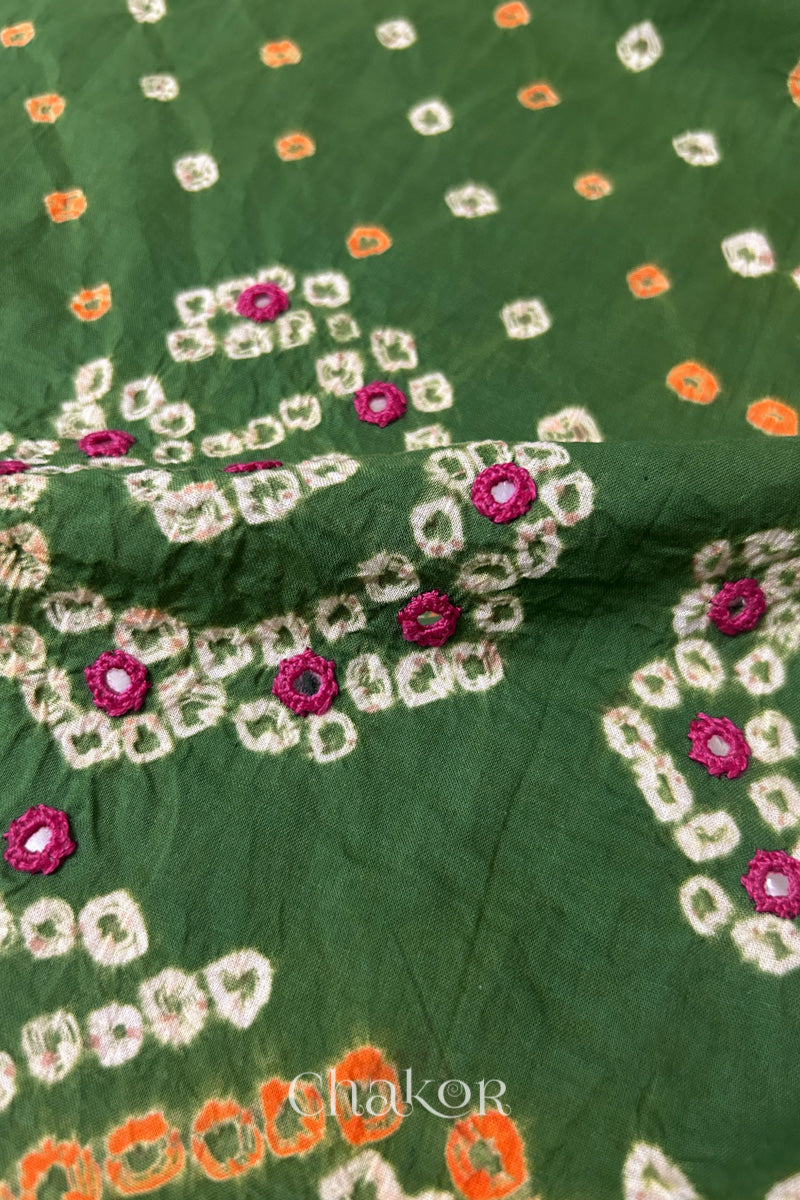 Close-up of Mehendi Green Kutch Bandhani blouse fabric showing Keri motifs and hand-embroidered mirror work.
