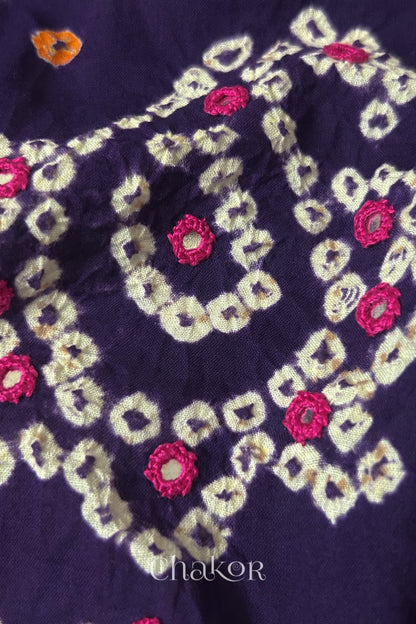 Detail of Kutch Bandhani Keri pattern with mirror embroidery on Purple cotton blouse fabric.
