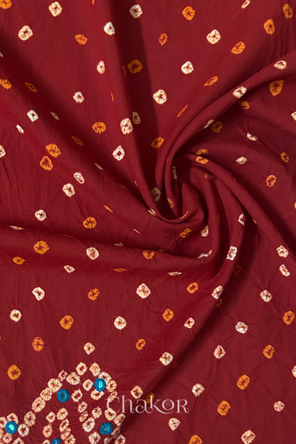 Red Bandhani cotton blouse fabric showing fine tie-dye dots and its soft drape.
