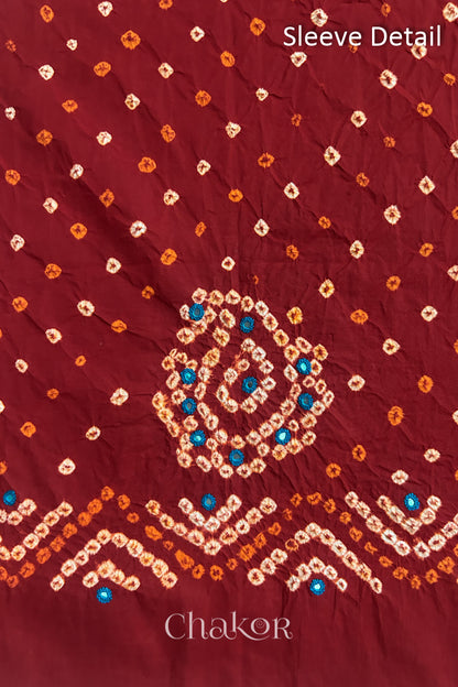 Red Kutch Bandhani cotton fabric with white tie-dye dots and Keri motif detail for sleeves.
