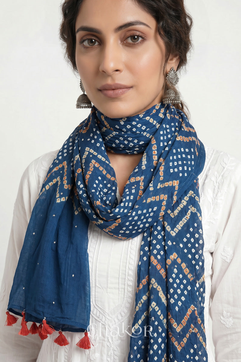 Indigo Blue Kutch Bandhani mulmul dupatta wrapped around woman's neck.
