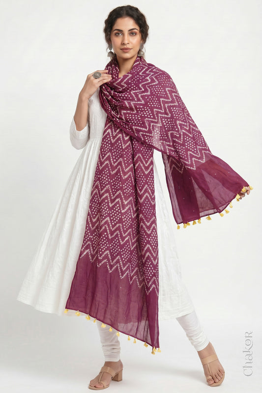 Plum pink Kutch Bandhani dupatta with mukaish embroidery in mercerised mulmul cotton shown in side drape styling.
