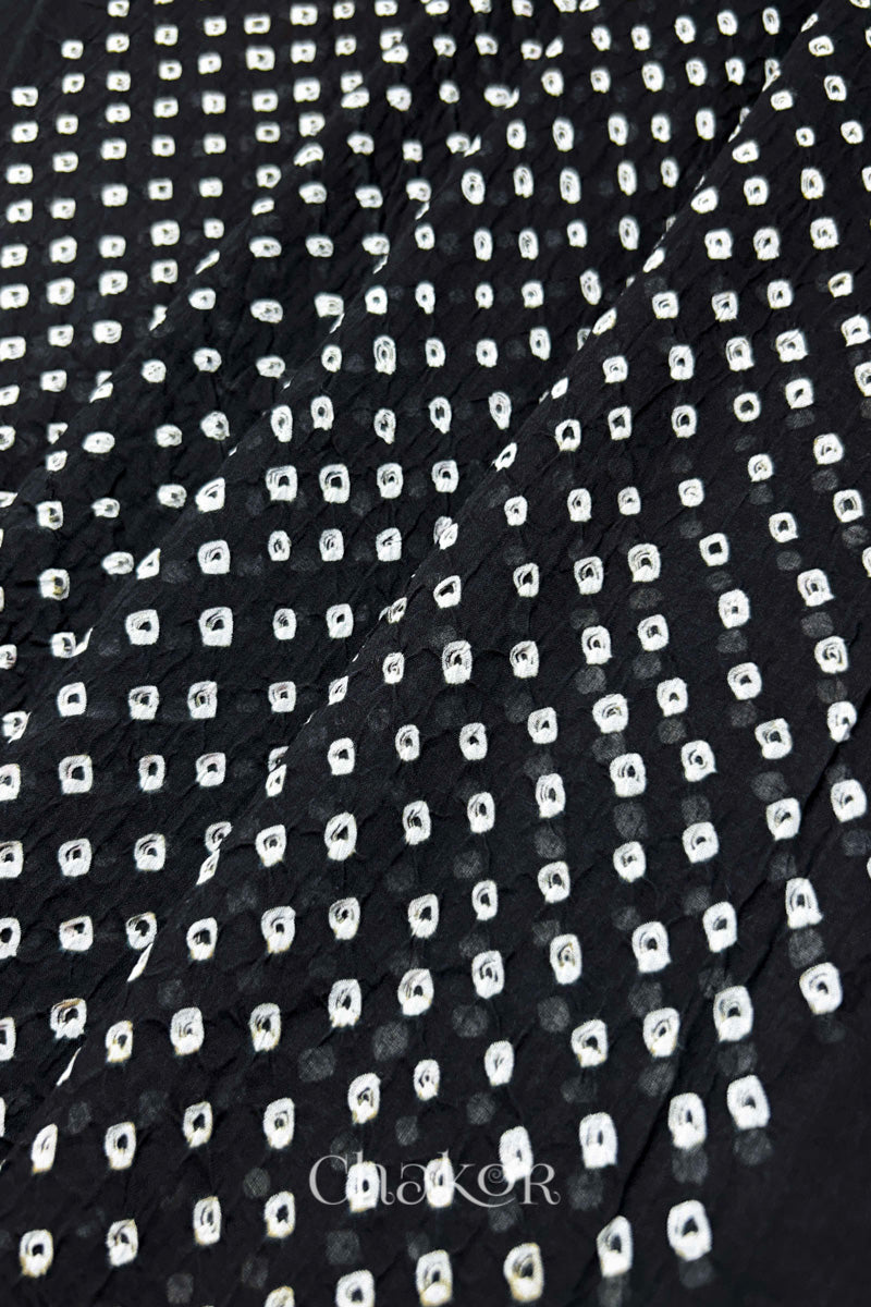 Chakor's black cotton dupatta with white bandhani pattern, creating a stylish visual effect.
