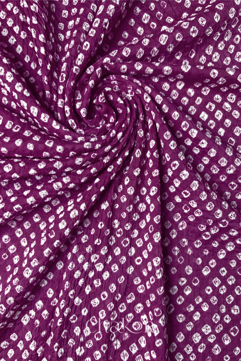 Chakor's magenta cotton bandhani dupatta | chunri featuring white dots, arranged in a swirling design.