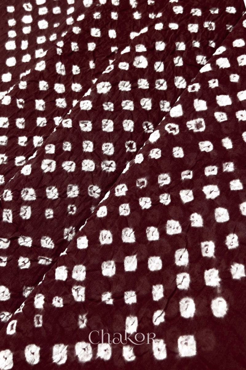 Close-up of Dark maroon Bandhani tie-dye dot pattern on mul cotton dupatta.
