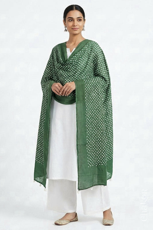 Model wearing Moss green Bandhani mul cotton dupatta with tie-dye dot pattern draped over a white kurta.