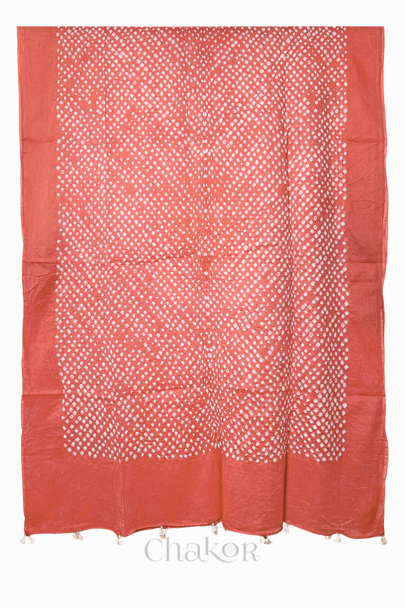 Full-length flat view of Dark Peach Bandhani mul cotton dupatta with all-over tie-dye pattern and tassels.
